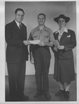 Walker Long giving check to Stella Fuller and unidentified man