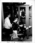 Three boys looking at display case of Cabell-Wayne Historical Society Exhibit