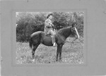 Fred O'Neal on horse, with two pistols, early 1900's