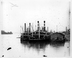 Steamboats docked at a wharf by Marshall University