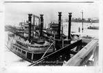 Two steamboats docked at a wharf by Marshall University